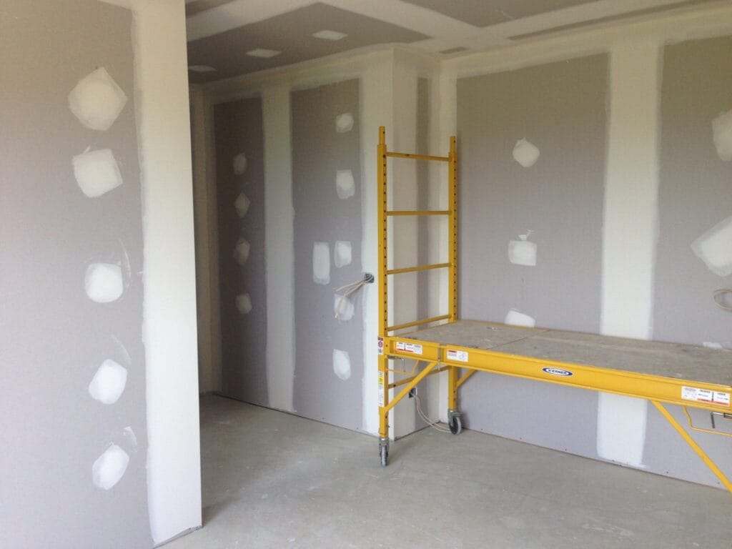 Plasterboard walls, stopped screw fixings and corners on grey plasterboard walls