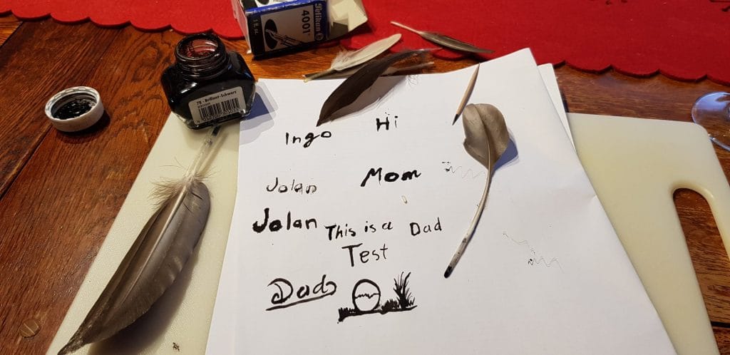 piece of paper with some feathers and ink bottle we used.