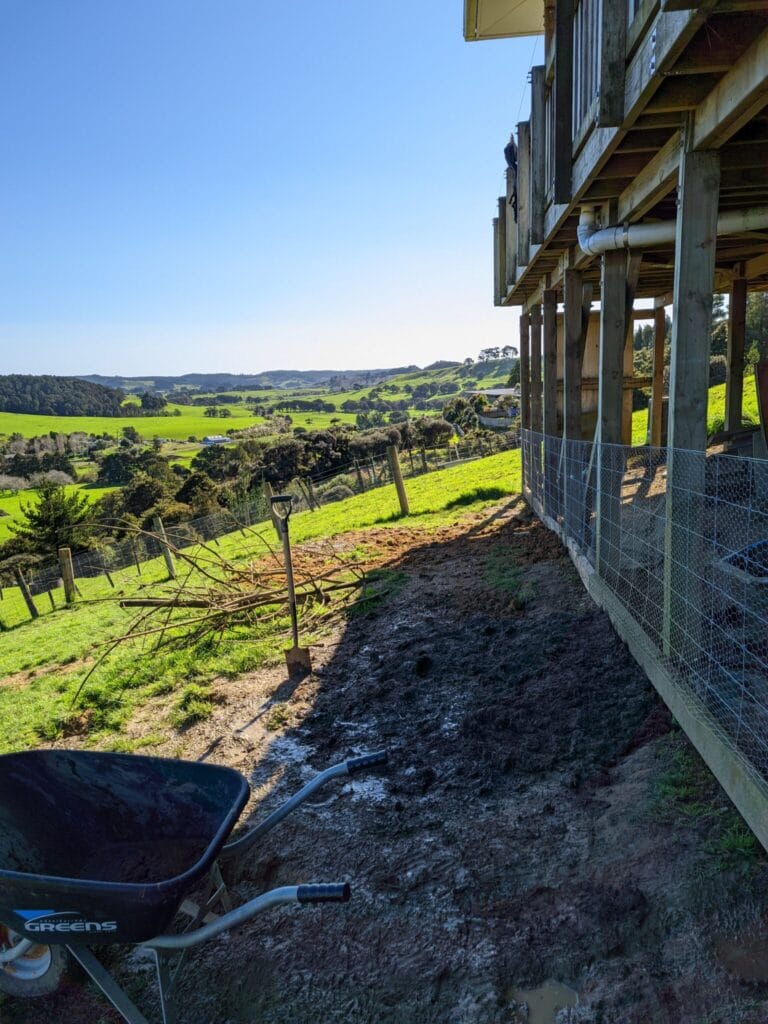 View along fenceline with fresh patches of soil