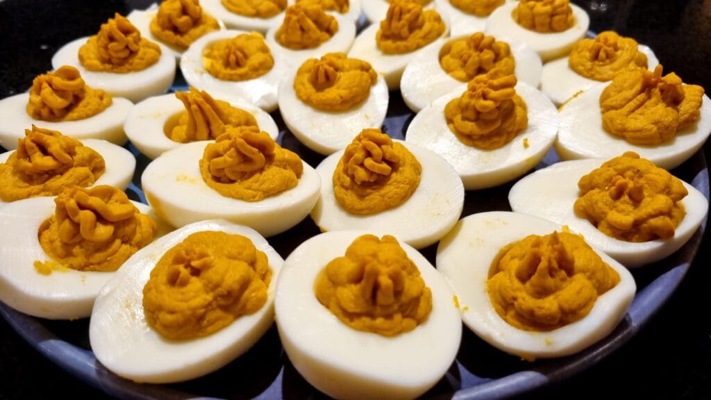 Deviled eggs, halved and filled with spiced egg yolk mix